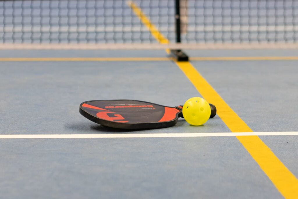 pickleball paddle laying on the court